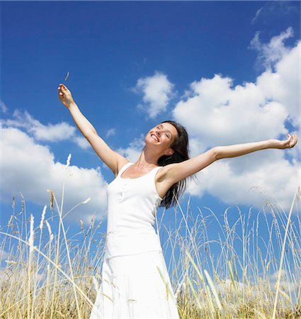 Woman in a field,  enjoying the sun Stock Photo - Premium Royalty-Free, Code: 649-02731690