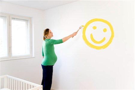 Pregnant woman painting nursery Stock Photo - Premium Royalty-Free, Code: 649-02732236