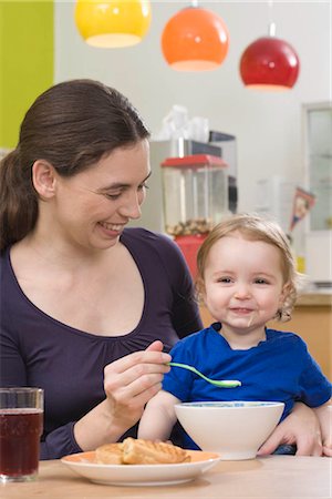 Mother feeding young girl,  happy Stock Photo - Premium Royalty-Free, Code: 649-02732511