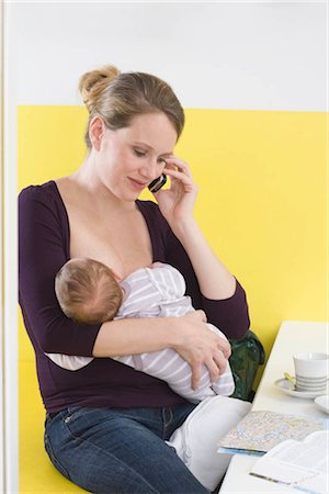 families talking on cell phones - Mother breastfeeding baby,  on the phone Stock Photo - Premium Royalty-Free, Code: 649-02732531