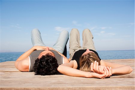 romantic couple sleeping together - Couple Relaxing On Pier Stock Photo - Premium Royalty-Free, Code: 649-03008548