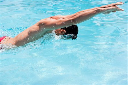 profile of person diving into pool - Man Swimming Butterfly Stroke Stock Photo - Premium Royalty-Free, Code: 649-03008567