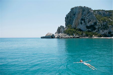 simsearch:649-02731278,k - Woman Swimming in blue,rocky bay Foto de stock - Royalty Free Premium, Número: 649-03008730