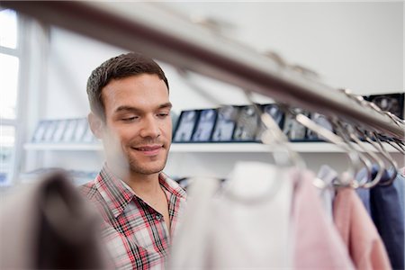 man shopping looking at shirts Stock Photo - Premium Royalty-Free, Code: 649-03008749