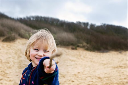 boy on beach pointing with stick Stock Photo - Premium Royalty-Free, Code: 649-03008848