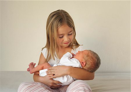 sibling newborn - Sister holding baby Stock Photo - Premium Royalty-Free, Code: 649-03009052