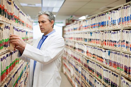 storage (office storage) - Male Doctor searching medical files Stock Photo - Premium Royalty-Free, Code: 649-03009503