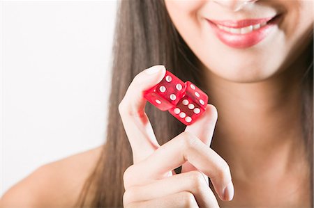 simsearch:400-07775500,k - Woman holding red dice Stock Photo - Premium Royalty-Free, Code: 649-03009626