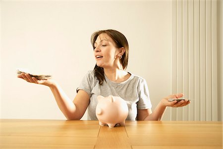 woman balancing money Stock Photo - Premium Royalty-Free, Code: 649-03009860