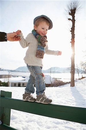 family enjoying snowfall - Scandinavian boy guided by fathers hand Stock Photo - Premium Royalty-Free, Code: 649-03010044