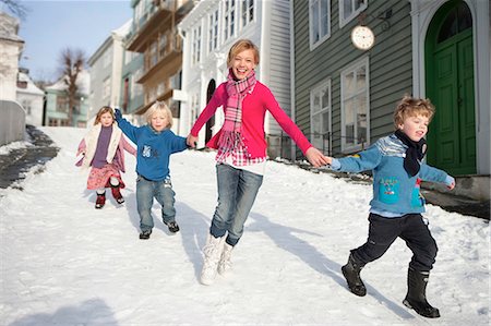 running teenage boy & girl - Scandinavian children running in snow Stock Photo - Premium Royalty-Free, Code: 649-03010042