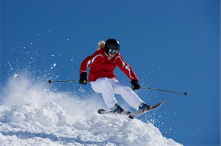 ski pole - Girl in red getting air time. Stock Photo - Premium Royalty-Free, Code: 649-03077557
