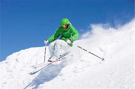 simsearch:649-08144991,k - Man in green skiing off piste. Fotografie stock - Premium Royalty-Free, Codice: 649-03077559