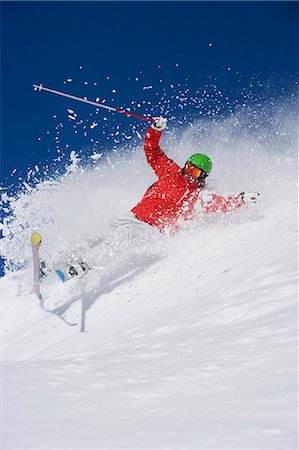 Man in red falling mid carve off-piste. Fotografie stock - Premium Royalty-Free, Codice: 649-03077563