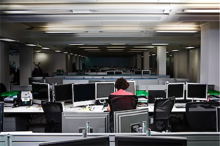 someone sitting at a desk backside - A business woman working late Stock Photo - Premium Royalty-Free, Code: 649-03077957