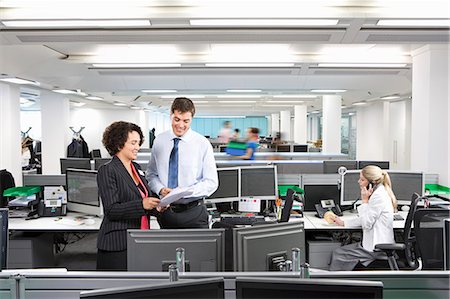 person sitting in chairs at desk side view - A busy modern office scene Stock Photo - Premium Royalty-Free, Code: 649-03077959