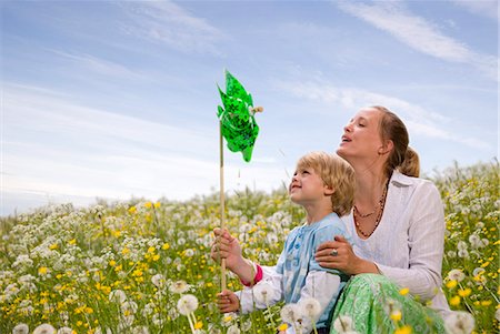 pictures of kids blowing a pinwheel - mother and son with green toy windmill Stock Photo - Premium Royalty-Free, Code: 649-03078038