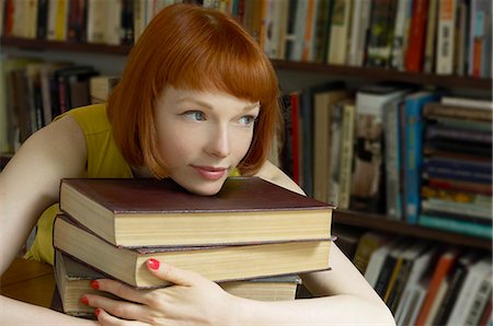 woman leaning on pile of books Stock Photo - Premium Royalty-Free, Code: 649-03078725
