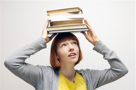 stack of books - woman balancing books on head Foto de stock - Sin royalties Premium, Código: 649-03078735