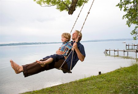 father teaching his child - father with son on swing Stock Photo - Premium Royalty-Free, Code: 649-03154037