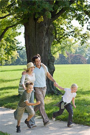 father son walking in field - A family walking in the park Stock Photo - Premium Royalty-Free, Code: 649-03154118