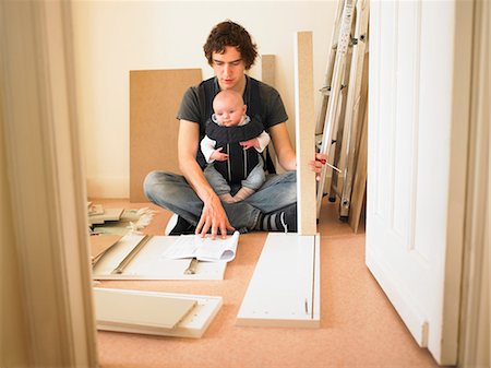 papa multitasking - Man with baby building furniture Stock Photo - Premium Royalty-Free, Code: 649-03154243