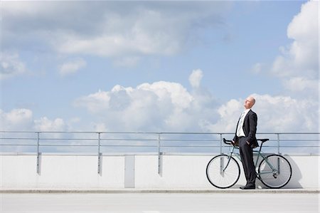 man with bycicle on car park Stock Photo - Premium Royalty-Free, Code: 649-03154635