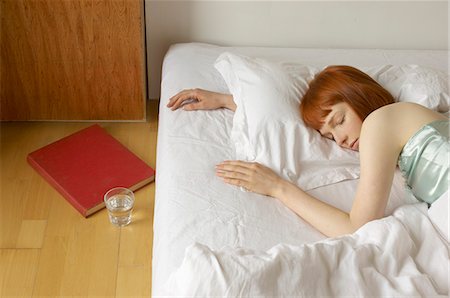 sleeping on floor - woman asleep in bed Stock Photo - Premium Royalty-Free, Code: 649-03154839