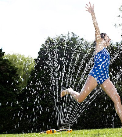 running sprinkler - Kids in Garden Stock Photo - Premium Royalty-Free, Code: 649-03154933