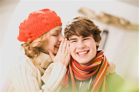 girl whispers boy something into his ear Stock Photo - Premium Royalty-Free, Code: 649-03153534