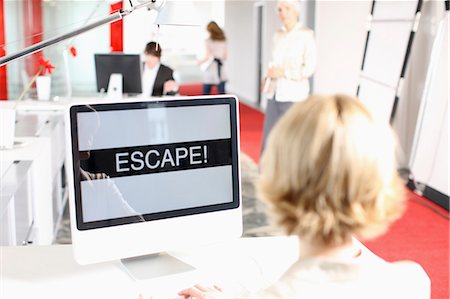 desperate - woman sitting on a desk and is working Stock Photo - Premium Royalty-Free, Code: 649-03153538