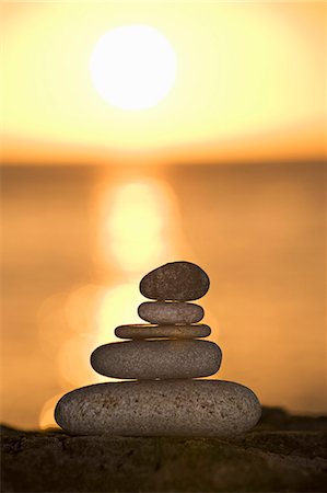 A stone stack against a setting sun Stock Photo - Premium Royalty-Free, Code: 649-03153635