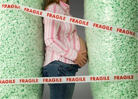 packing peanuts - pregnant woman in protective packaging Stock Photo - Premium Royalty-Free, Code: 649-03153705