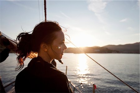 sailboat sunset - woman on a boat watching the sunset Stock Photo - Premium Royalty-Free, Code: 649-03153756