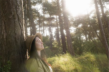 secluded - Woman relaxing against tree Stock Photo - Premium Royalty-Free, Code: 649-03153852