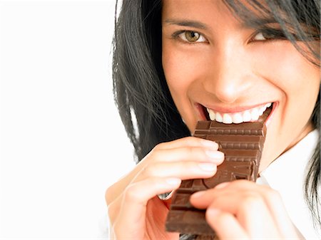 eating indulgent chocolate - Woman eating chocolate Stock Photo - Premium Royalty-Free, Code: 649-03153887