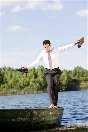 businessman balancing on rowboat Stock Photo - Premium Royalty-Free, Code: 649-03294243