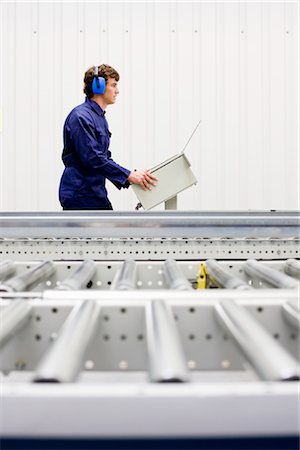 factory conveyor belt - workman at workplace Stock Photo - Premium Royalty-Free, Code: 649-03294339