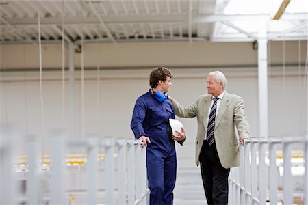 european railing - workman talking with boss Stock Photo - Premium Royalty-Free, Code: 649-03294340