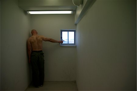 people inside jail cell - man pointing to window Stock Photo - Premium Royalty-Free, Code: 649-03294378