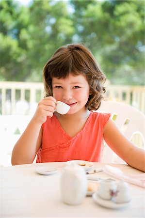 A young girl having tea on a terrace Stock Photo - Premium Royalty-Free, Code: 649-03295928