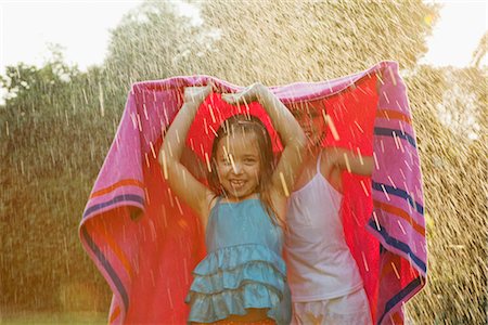 preteen wet - Girls standing under towel in rain Stock Photo - Premium Royalty-Free, Code: 649-03296133