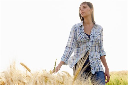 Woman walking in a wheat field Stock Photo - Premium Royalty-Free, Code: 649-03296277