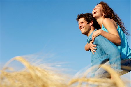 Man carrying woman in a wheat field Stock Photo - Premium Royalty-Free, Code: 649-03296354