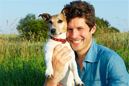 Man with dog, in a wheat field Stock Photo - Premium Royalty-Free, Code: 649-03296362