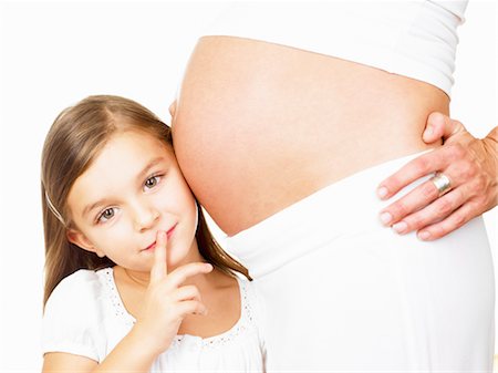 pregnant daughter - Girl next to her mother's pregnant belly Stock Photo - Premium Royalty-Free, Code: 649-03296454