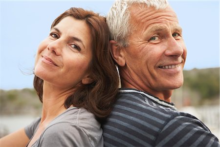 simsearch:649-03768999,k - Middle aged couple, back to back, smiles Stock Photo - Premium Royalty-Free, Code: 649-03296502