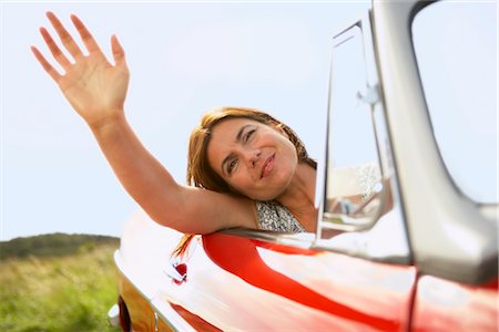 mid-aged woman's hand out of car window Stock Photo - Premium Royalty-Free, Code: 649-03296542