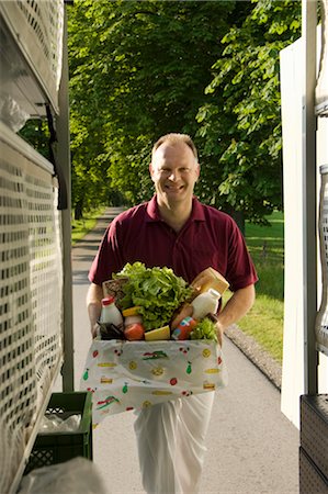 picture of some delivering groceries - Deliveryman with a box Stock Photo - Premium Royalty-Free, Code: 649-03296642