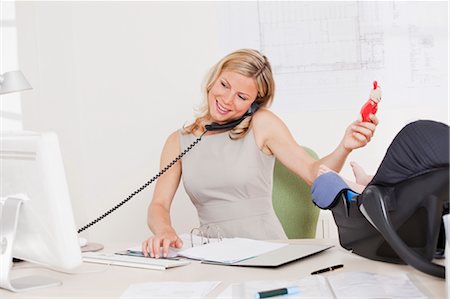 parents busy - Business woman with baby. Stock Photo - Premium Royalty-Free, Code: 649-03297119
